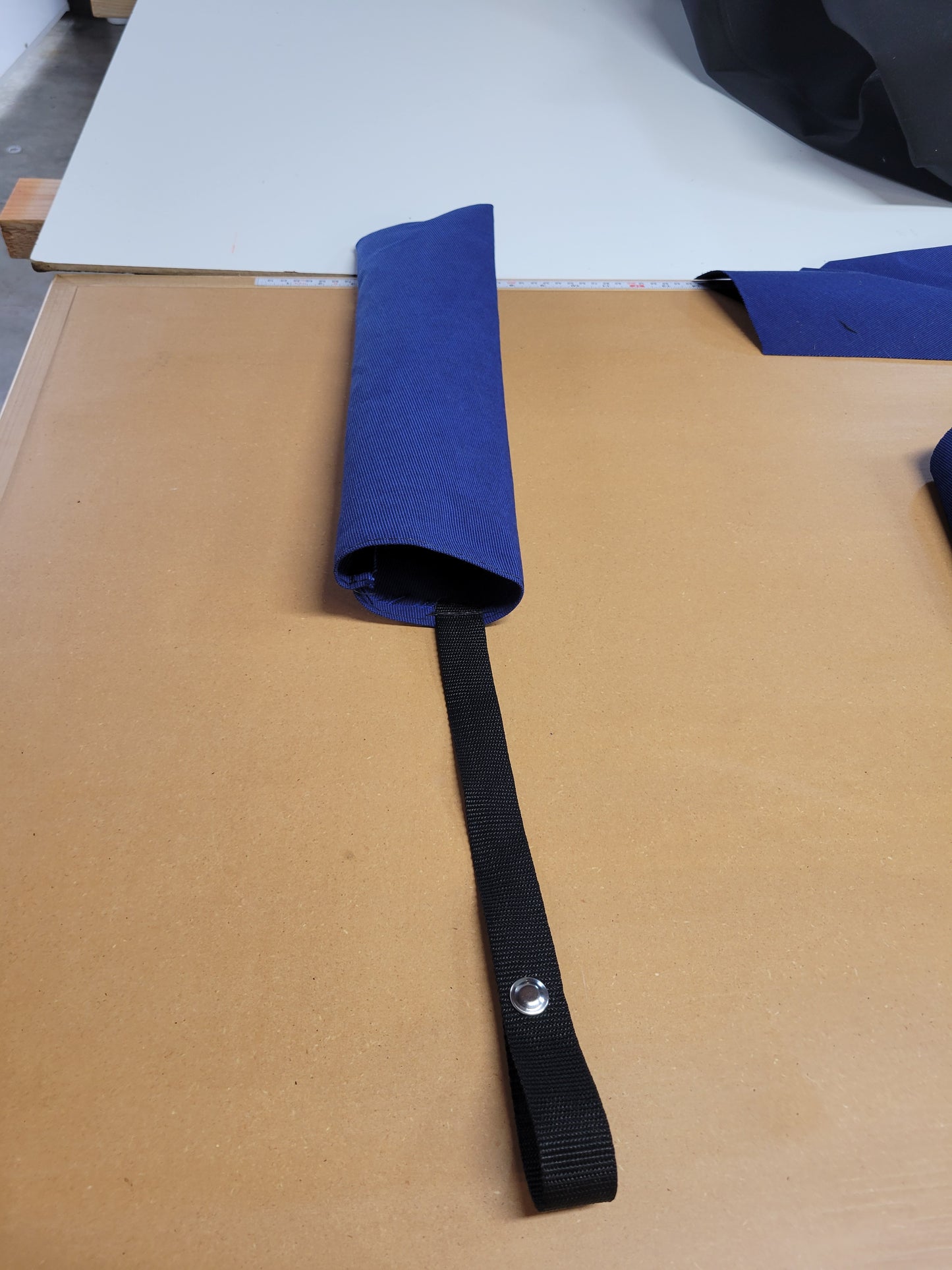 Close-up of a Navy Blue flag cover with a heavy-duty black strap and snap closure.